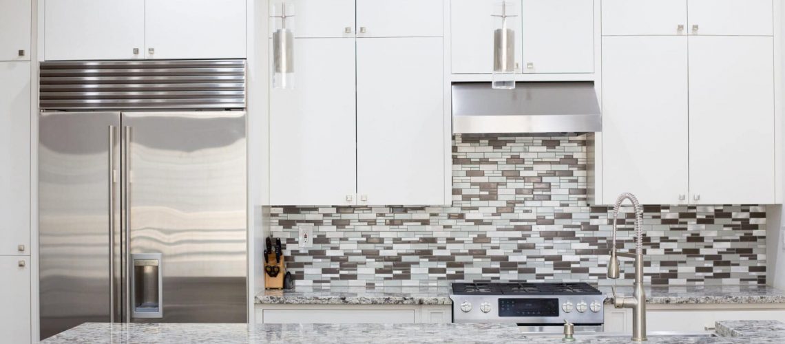 Snapshot of interior modern kitchen with granite countertop island and smart refrigerator