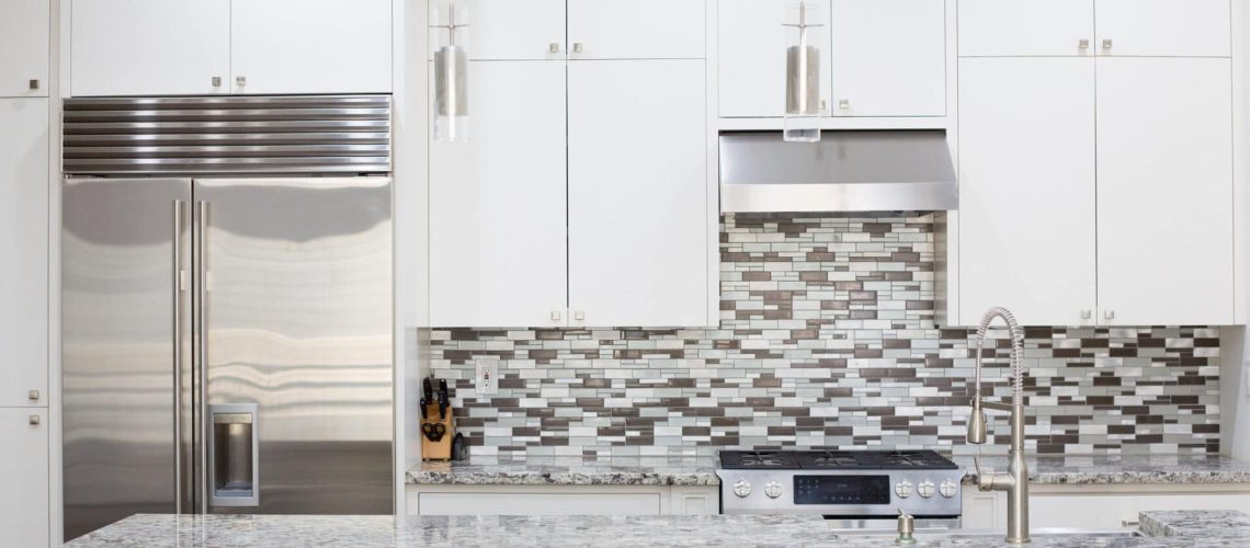 Snapshot of interior modern kitchen with granite countertop island and smart refrigerator