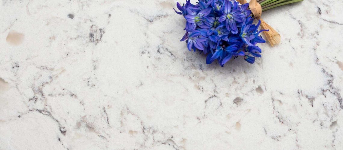 Spring blue wild flowers Scilla bouquet on Delta White quartz kitchen worktop