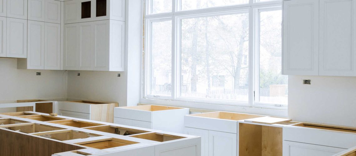 Wooden cabinets installation of in the white modular kitchen of installation base cabinets