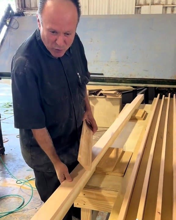 LuxeCraft craftsman explaining custom crown molding profiles in the San Antonio shop