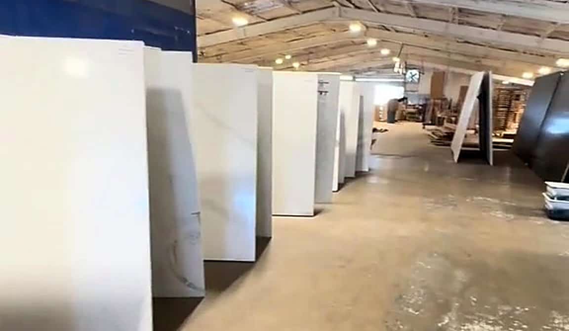 Rows of full quartz and natural stone slabs in the LuxeCraft slab warehouse in San Antonio